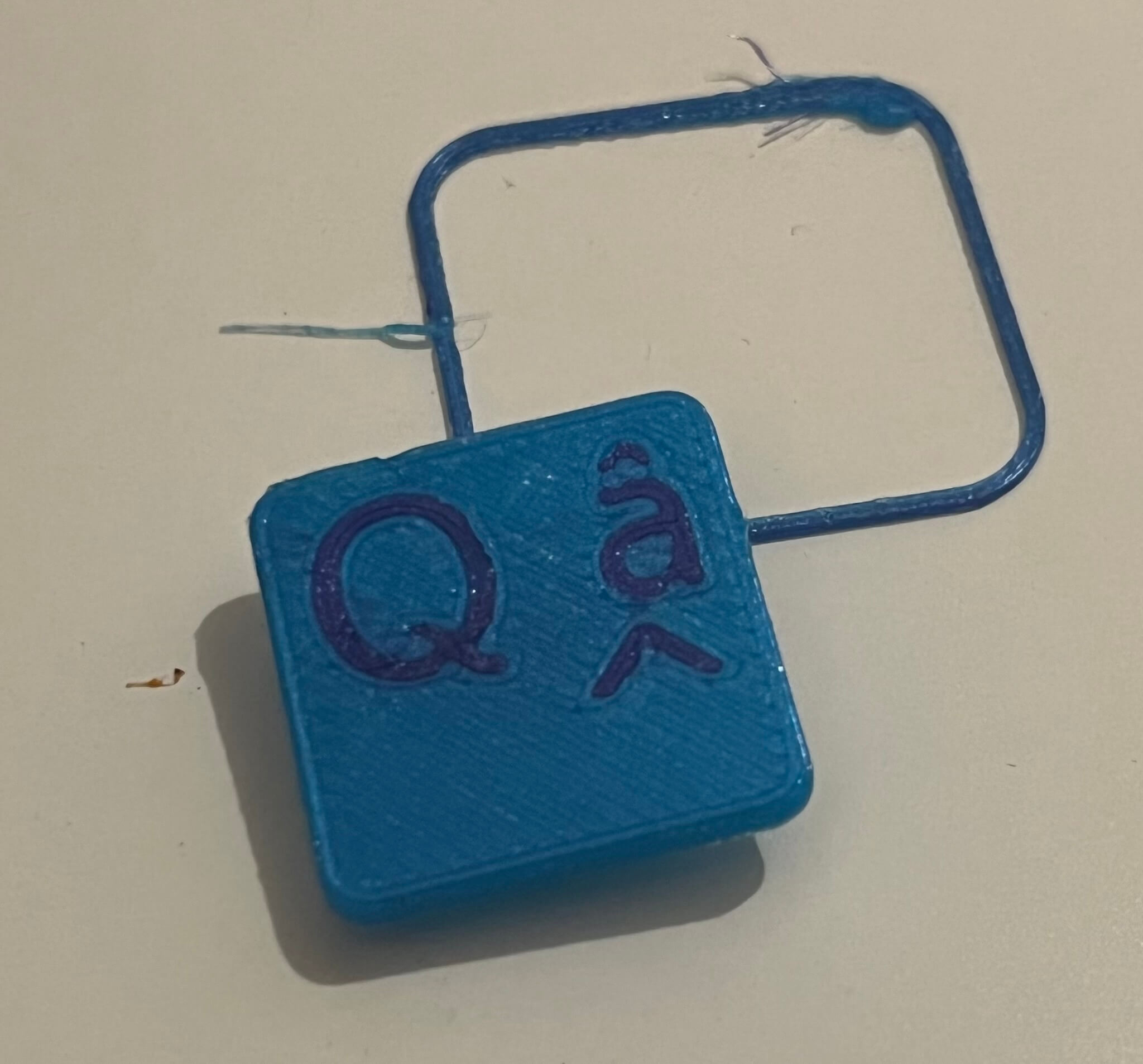 The blue keycap and its purple text.