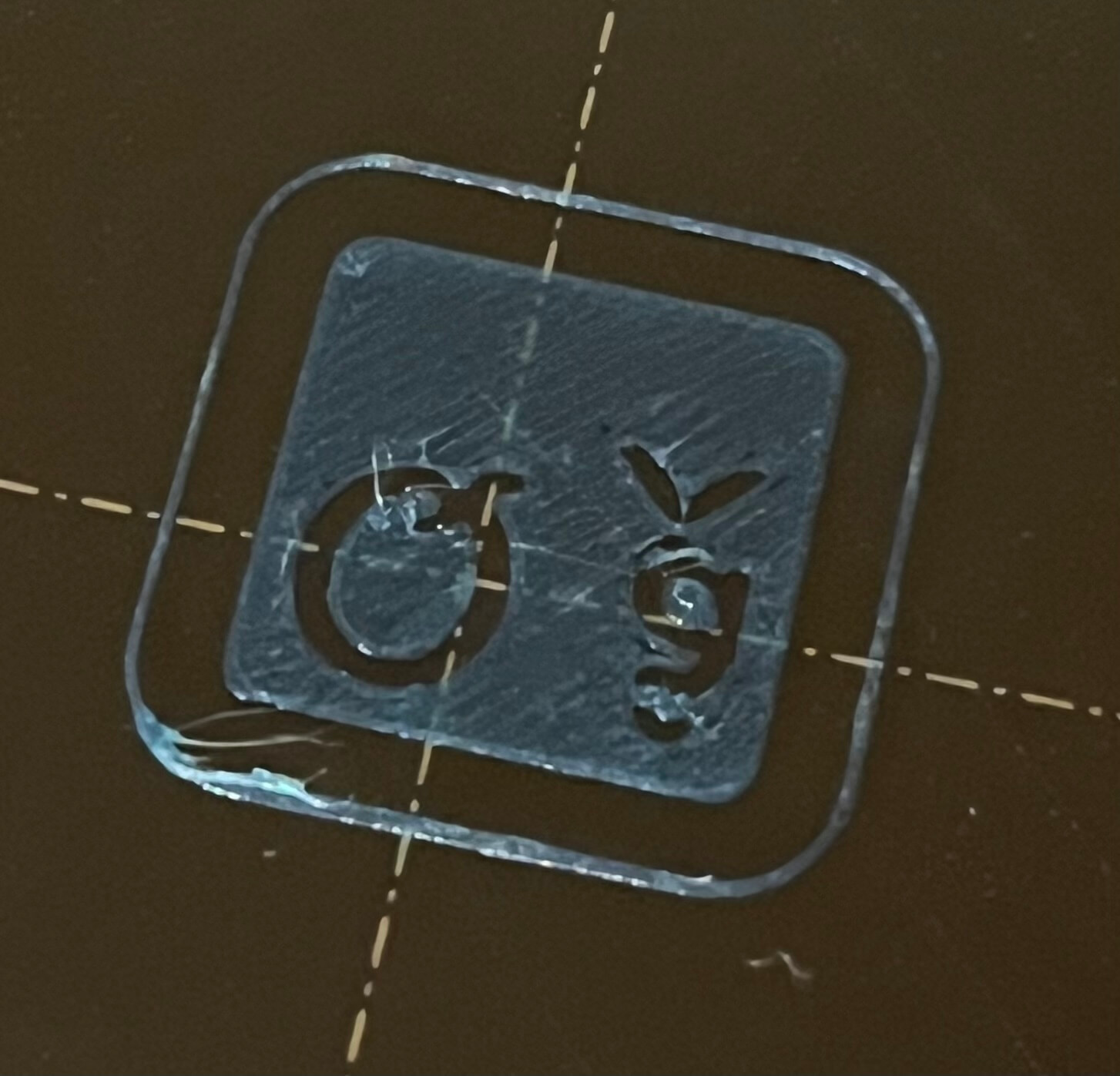 The rounded square printed in blue filament, without the text